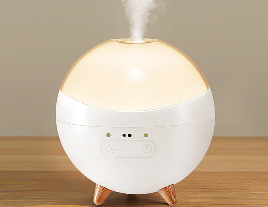 Coremet Ltd ultrasonic aroma diffuser and humidifier in a business kit, with a sleek design and visible mist output.