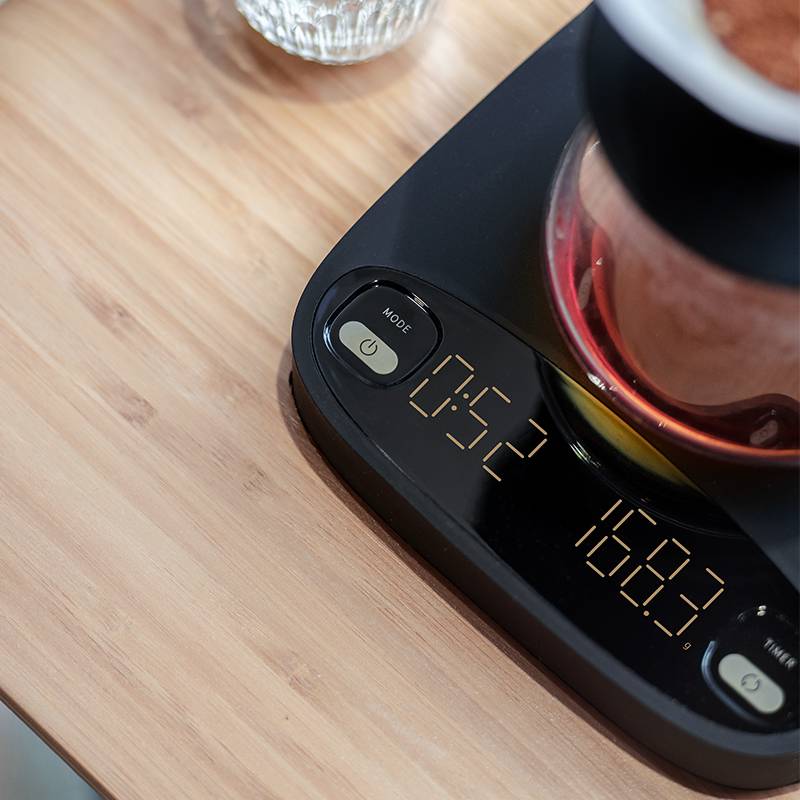 Handcrafted Coremet Ltd precision coffee weighing scale from business kits, featuring digital display and sleek design.