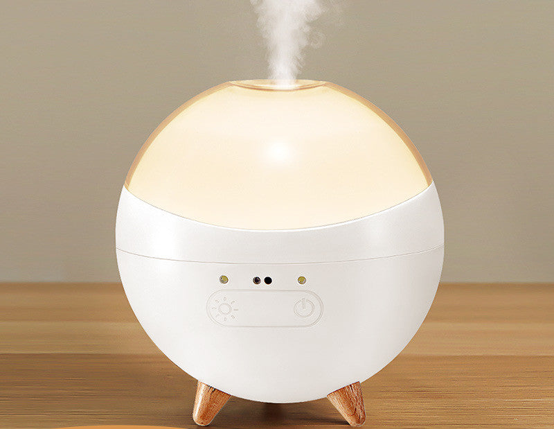 Coremet Ltd ultrasonic aroma diffuser and humidifier in a business kit, with a sleek design and visible mist output.