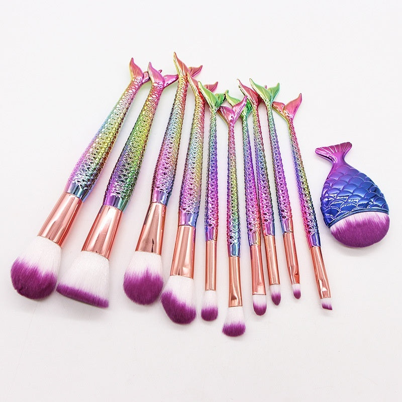 Set of 10 mermaid-themed makeup brushes from Coremet Ltd, arranged in a business kit with colorful handles and soft bristles.